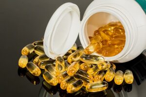 capsules spilling out of a bottle - Vitamin Shop Signs